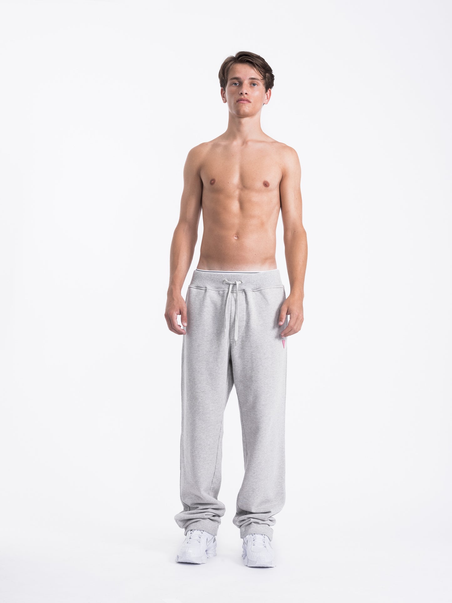 Man wearing gray sweatpants on a white background